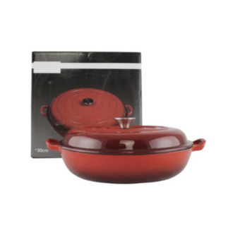 cratiță de fontă roșie cu capac în fața cutiei ambalaj